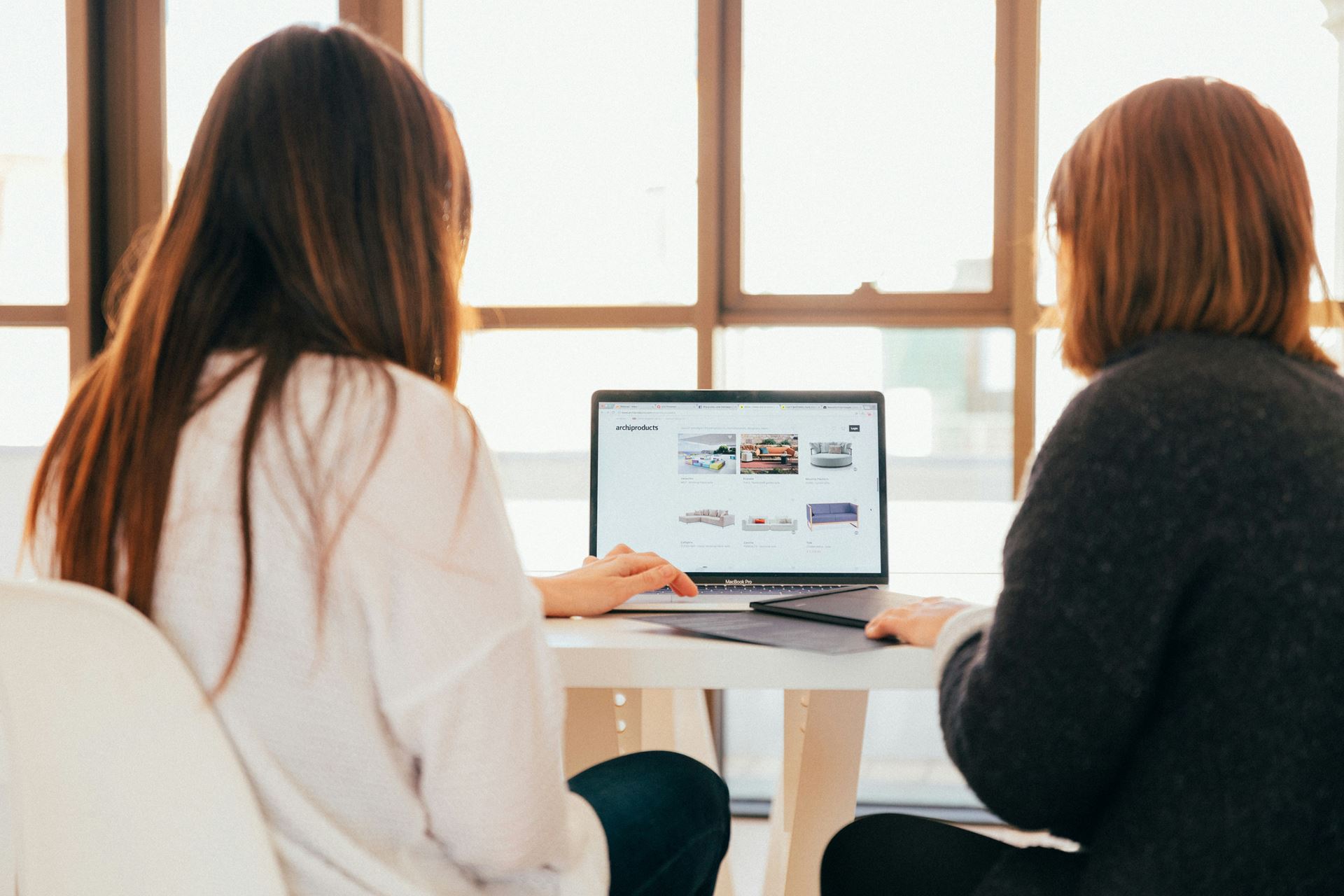 Two woman looking at a laptop