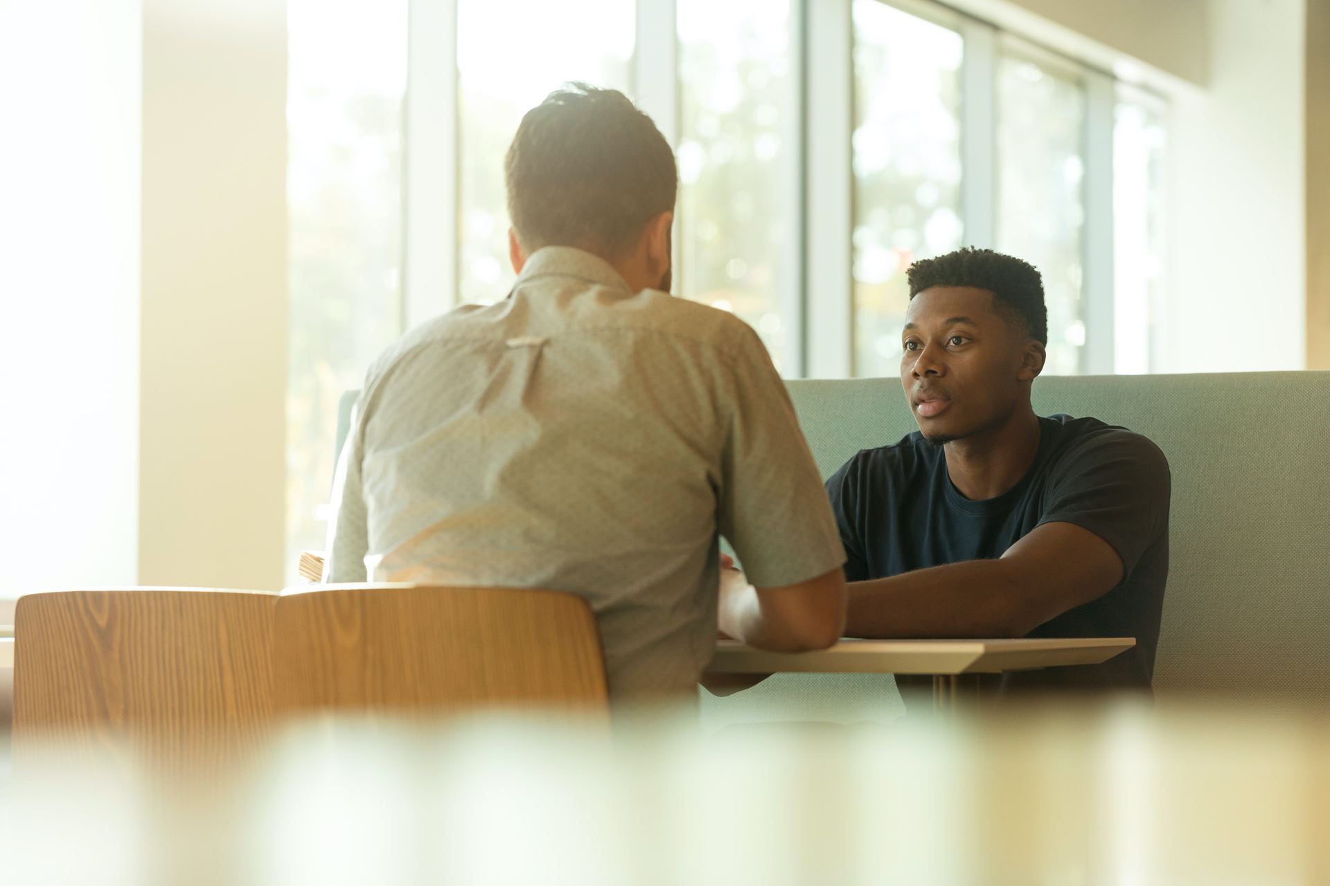 two men facing eachother and having a conversation