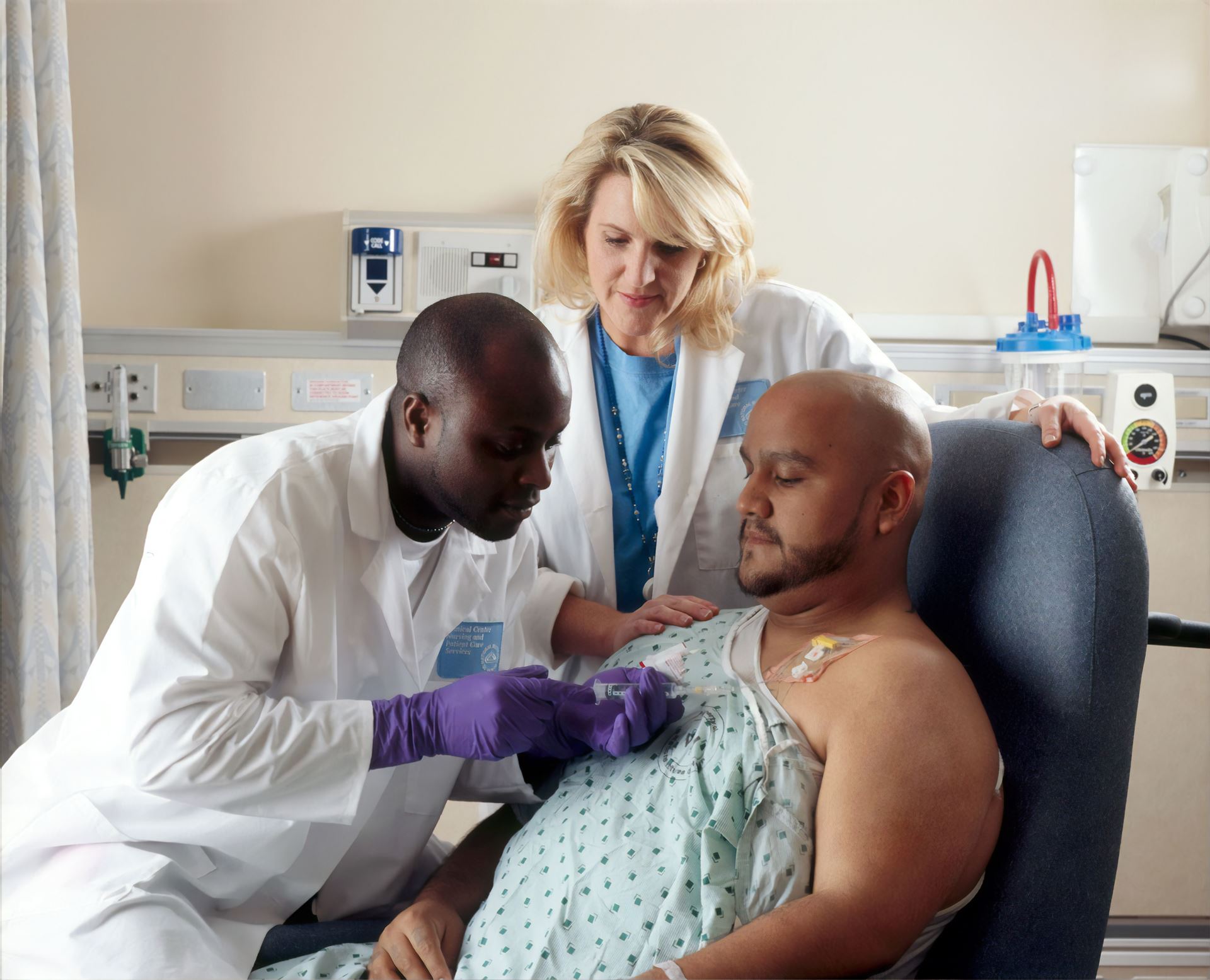 a trainee doctor with a patient and supervisor